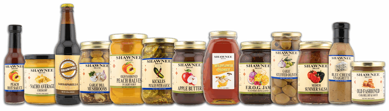 A variety of Shawnee-branded jars and bottles containing sauces, pickles, honey, and preserves are arranged in a row against a black background.