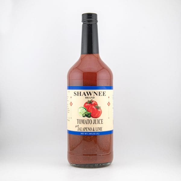 A bottle of Shawnee brand tomato juice flavored with jalapeño and lime, featuring illustrated tomatoes and limes on the label.