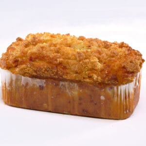 A loaf of bread with a golden, crumbly crust, placed on a plain white surface. The bread appears freshly baked and delicious.