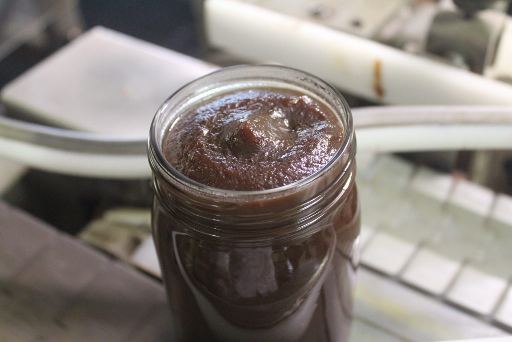A filled jar of apple butter from our plant.